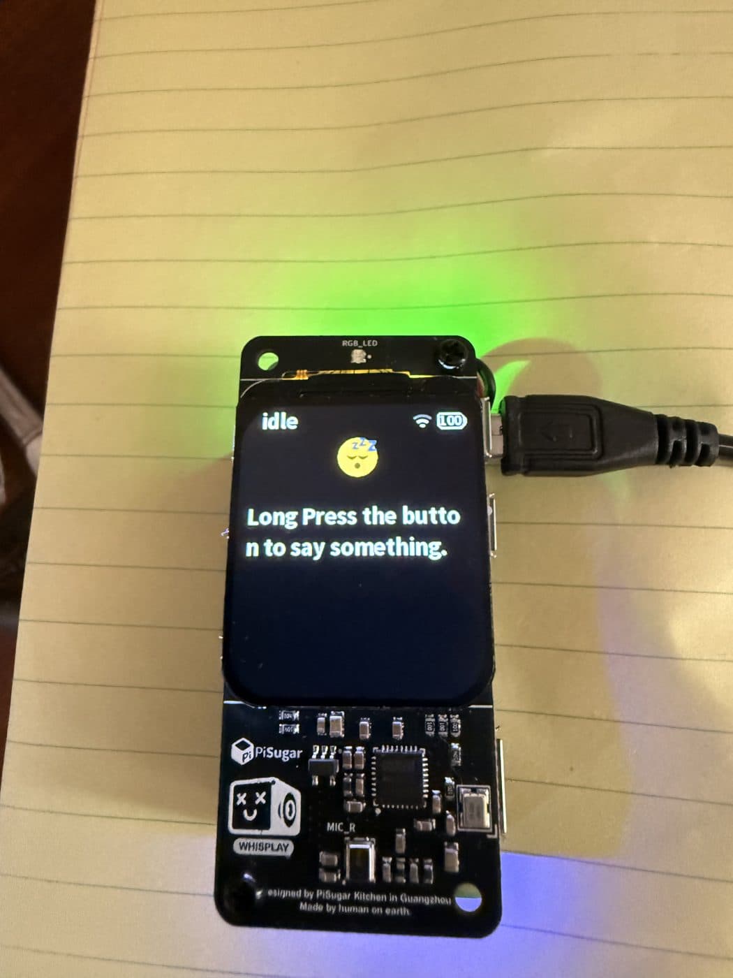 Early board, idle: “Long press the button to say something.”